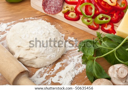 Ball of Pizza Dough on Wooden Surface and Pizza Ingredients
