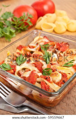 stuffed shell pasta with tomato sauce and cheese baked in a casserole dish and ingredients