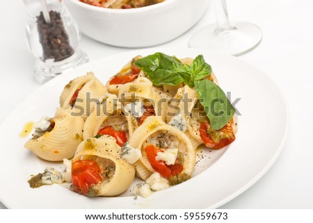 plate of stuffed shell pasta baked with cheese and tomato sauce