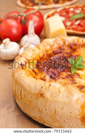 thick chicago-style deep- dish stuffed pizza with ingredients on a table