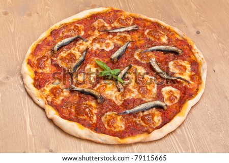 thin-crust pizza alla napoletana with anchovies, mozzarella and tomato sauce