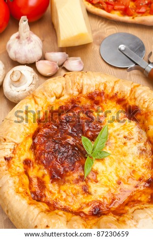 thick chicago-style deep- dish stuffed pizza with ingredients on a table