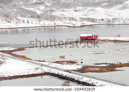 Red norway house on sea in fjord
