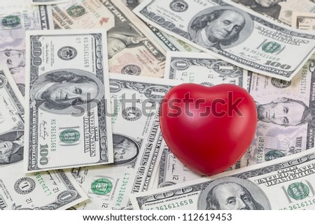 Red heart on US dollars background (Love for Money concept)