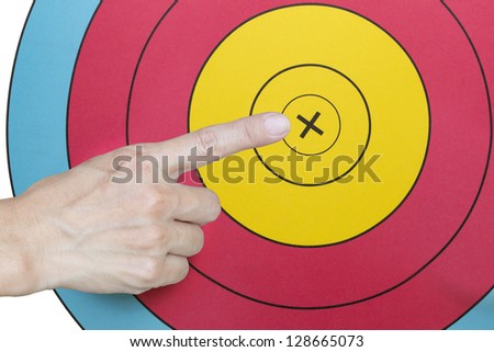 Hand with index finger on archery target