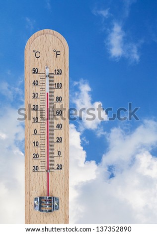 Wood thermometer on sky blue