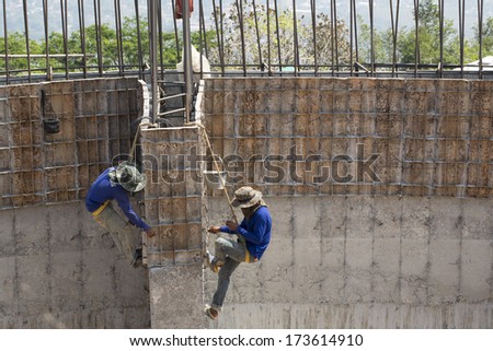 construction workers collaborating in the installation of concre