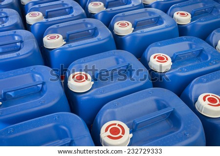 Blue plastic barrels containing chemicals in storage