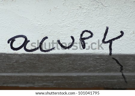 Traces of Occupy Remain. Occupy, as in Occupy Wall Street, written in marker on painted bulkhead by Union Square MTA entrance.