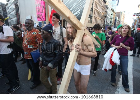NEW YORK CITY - MAY 1: Occupy Wall Street member recreates the Via Dolorosa using a wood cross & cotton underpants in honor of International Workers\' Day  on May 1 2012 in New York City