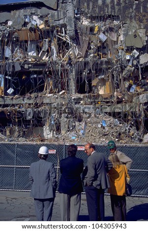 LOS ANGELES, CA - 19 JAN: Building inspectors contemplate collapsed office structure in the wake of the Northridge Earthquake on 19 January 1994 in Los Angeles, CA.