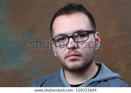 Headshot of Man with Glasses/Close up shot of man with horn rim glasses with brown portrait background