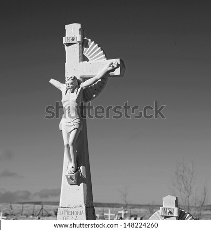 Weather-Damaged Crucifix rendered in black & white in a cemetery outside Seligman, Arizona, population 546, along US 40