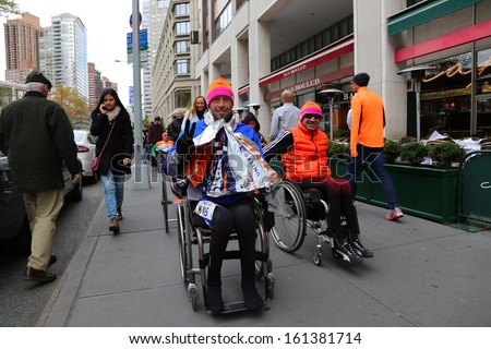NEW YORK CITY - NOVEMBER 3 2013: the 42nd IMG New York City Marathon commenced after a hiatus due to Hurricane Sandy. Wheelchair division finishers flash triumphantly November 3 2013 in New York City.