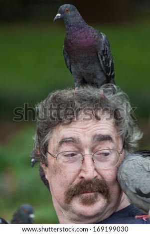 NEW YORK CITY - SEPTEMBER 4 2011: Birdman of Washington Square Park/Paul Zig, a fixture in Lower Manhattan's Washington Square Park due to his affinity for the park's resident pigeons