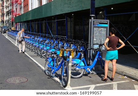 NEW YORK CITY - SEPTEMBER 11 2013: New York City Bike Share, sponsored by Citibank, creates racks of distinctive blue bicycles throughout NYC which users can ride from one Bike Share spot to another
