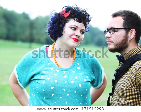 High key image of attractive young couple in Prospect Park, Brooklyn with grass & trees in background