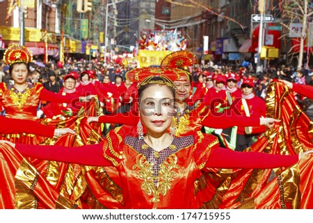 NEW YORK CITY - FEBRUARY 2 2014: Chinese Lunar New Year, the Year of the Horse, was celebrated by a parade in Manhattan\'s Chinatown. Women dance troup in vivid red dresses & fan-shaped hats