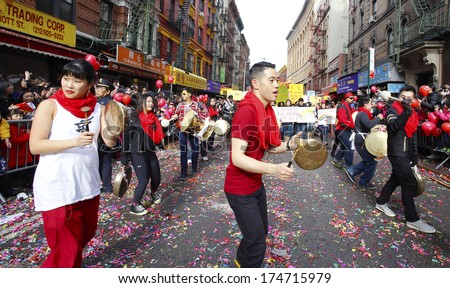 NEW YORK CITY - FEBRUARY 2 2014: Chinese Lunar New Year, the Year of the Horse, was celebrated by a parade in Manhattan\'s Chinatown. Dancers with percussion player along Mott Street.