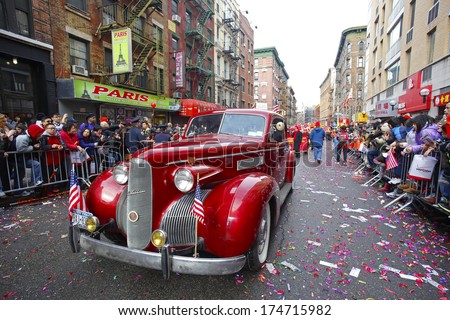 NEW YORK CITY - FEBRUARY 2 2014: Chinese Lunar New Year, the Year of the Horse, was celebrated by a parade in Manhattan's Chinatown. Vintage LaSalle sedan makes its way along Mott Street.