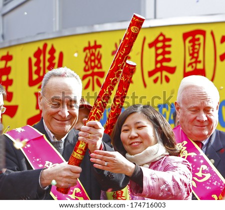 NEW YORK CITY - FEBRUARY 2 2014: Chinese Lunar New Year, the Year of the Horse, was celebrated by a parade in Manhattan\'s Chinatown. US Senator Charles Schumer gets help firing a confetti bomb