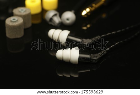 IEM array/In Ear Monitors fit into the auditory canal itself, shown here with various ear fittings & plug adapters