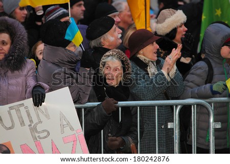 NEW YORK CITY - MARCH 2 2014: EuroMaidan, a pro-western Ukranian advocacy group, protested Russian intervention in the Ukraine by marching to the Russian consulate. Elderly woman at protest on 91st St