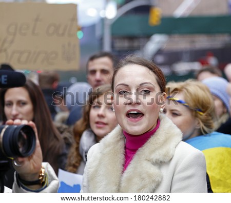 NEW YORK CITY - MARCH 2 2014: EuroMaidan, a pro-western Ukranian advocacy group, protested Russian intervention in the Ukraine by marching to the Russian consulate. Young woman addressing marchers