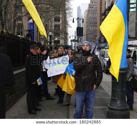 NEW YORK CITY - MARCH 2 2014: EuroMaidan, a pro-western Ukranian advocacy group, protested Russian intervention in the Ukraine by marching to the Russian consulate. Ukrainian flags along Fifth Avenue