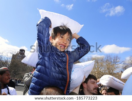 NEW YORK CITY - APRIL 5 2014: the first Saturday of April is International Pillow Fight Day, observed this time at Washington Square Park in Lower Manhattan. Kids go one on one from shoulder height