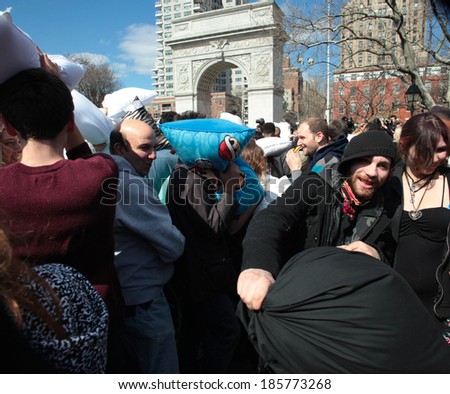 NEW YORK CITY - APRIL 5 2014: the first Saturday of April is International Pillow Fight Day, observed this time at Washington Square Park in Lower Manhattan. Mass of people with arch in background