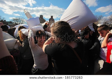 NEW YORK CITY - APRIL 5 2014: the first Saturday of April is International Pillow Fight Day, observed this time at Washington Square Park in Lower Manhattan. One on one in midst of crowd