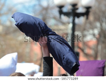 NEW YORK CITY - APRIL 5 2014: the first Saturday of April is International Pillow Fight Day, observed this time at Washington Square Park in Lower Manhattan. Black pillow held aloft prior to start