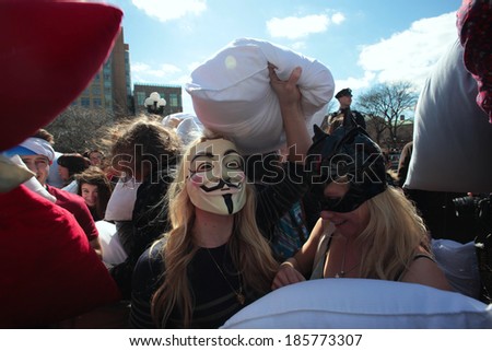 NEW YORK CITY - APRIL 5 2014: the first Saturday of April is International Pillow Fight Day, observed this time at Washington Square Park in Lower Manhattan. Participant in Guy Fawkes mask