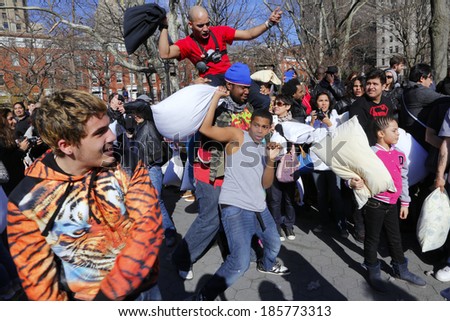NEW YORK CITY - APRIL 5 2014: the first Saturday of April is International Pillow Fight Day, observed this time at Washington Square Park in Lower Manhattan. Array of pillow fighters in sunlight