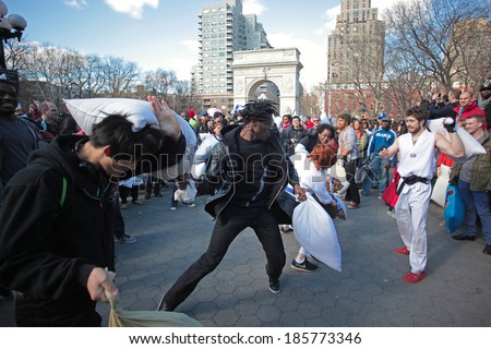 NEW YORK CITY - APRIL 5 2014: the first Saturday of April is International Pillow Fight Day, observed this time at Washington Square Park in Lower Manhattan. Man takes on two simultaneous opponents