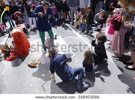 NEW YORK CITY - APRIL 20 2014: The annual Easter Parade & Bonnet festival stretches from St. Patrick\'s Cathedral on 5th Avenue to 55th Street. Street performers play to children audience