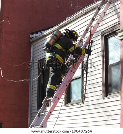 NEW YORK CITY - MAY 1 2014: Several FDNY engine & ladder companies respond to a house fire in the Gowanus neighborhood of Brooklyn.