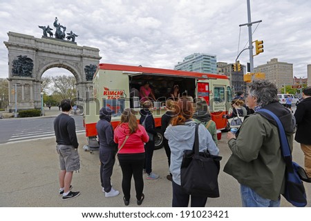 NEW YORK CITY - MAY 4 2014: the Prospect Park Alliance sponsors a bimonthly Food Truck Rally at Grand Army Plaza during spring & summer months. Queue by Kimchi Korean Barbecue with arch in background