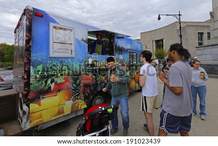 NEW YORK CITY - MAY 4 2014: the Prospect Park Alliance sponsors a bimonthly Food Truck Rally at Grand Army Plaza during spring & summer months. Tropical motif coffee & tea truck with customers queued