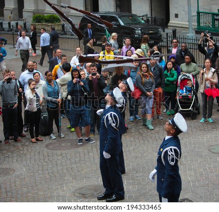 NEW YORK CITY - MAY 22 2014: The United States Coast Guard Silent Drill Team performs rifle slinging routines for the public on Wall Street before the New York Stock Exchange to mark Fleet Week