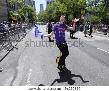NEW YORK CITY - JUNE 1 2014: The 50th annual Israel Day Parade filled Fifth Avenue with politicians, revelers & a few protestors marking Israel\'s 66th anniversary. Riding a unicycle up Fifth Avenue