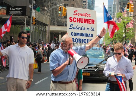 NEW YORK CITY - JUNE 8 2014: The 57th annual Puerto Rico Day Parade filled 5th Avenue with some 80,000 marchers & more than one million spectators. US Senator Charles Schumer working bullhorn