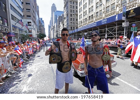 NEW YORK CITY - JUNE 8 2014: The 57th annual Puerto Rico Day Parade filled 5th Avenue with some 80,000 marchers & more than one million spectators. Boxing champs pose with championship belts