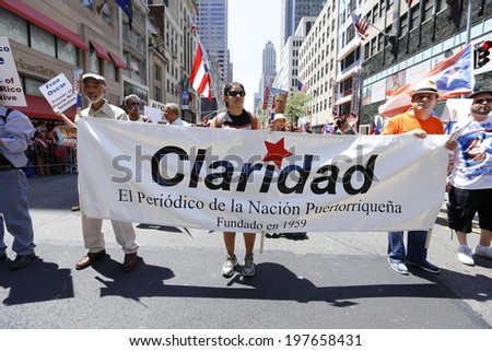 NEW YORK CITY - JUNE 8 2014: The 57th annual Puerto Rico Day Parade filled 5th Avenue with some 80,000 marchers & more than one million spectators. Claridad banner