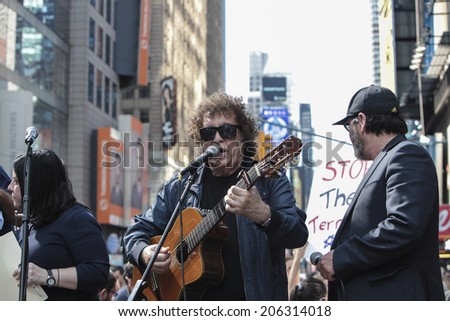 NEW YORK CITY - JULY 20 2014: several thousand supporters of Israeli actions in Gaza staged a rally in Times Square. Singer Ron Eliron (center) performs on stage flanked by Benny Elbaz (at right)