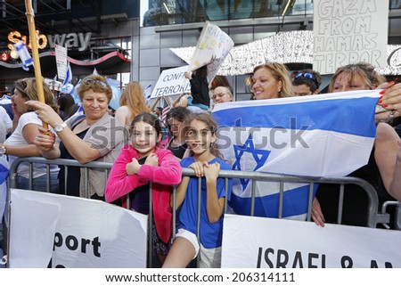 NEW YORK CITY - JULY 20 2014: several thousand supporters of Israeli actions in Gaza staged a rally in Times Square. Kids at barrier next to mom with Israeli flag