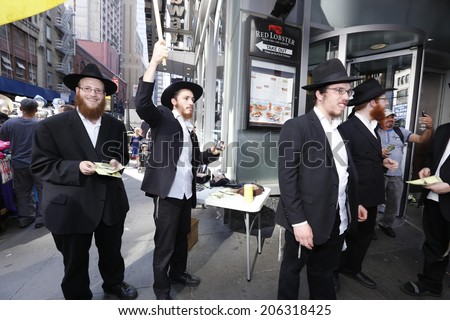 NEW YORK CITY - JULY 20 2014: Several thousand attended a rally in Times Square to support Israel\'s recent actions in Gaza. Chabadniks with tefillin awaiting Jewish male passersby