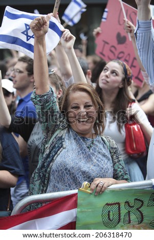 NEW YORK CITY - JULY 20 2014: Several thousand attended a rally in Times Square to support Israel\'s recent actions in Gaza. Female Israel supporter waving flags