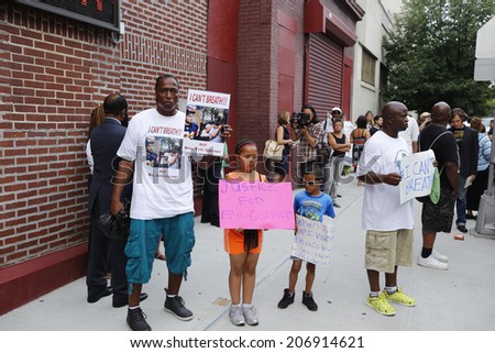 NEW YORK CITY - JULY 23 2014: Funeral services for Eric Garner, the Staten Island resident who died while being taken into custody by NYPD.  Activist family with signs